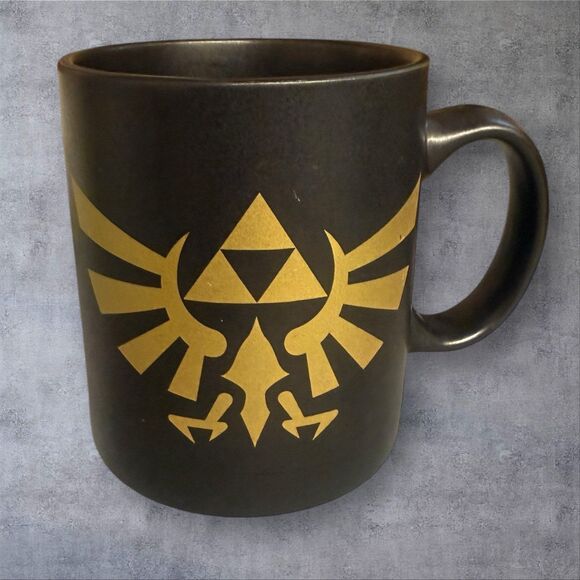The Legend of Zelda Gold Triforce Black Ceramic Mug
By Paladone; Gamers Coffee - Picture 1 of 5